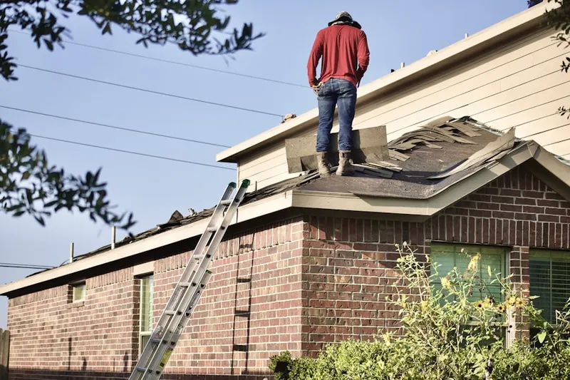 Professional roofer working on a residential roof in Defense Heights